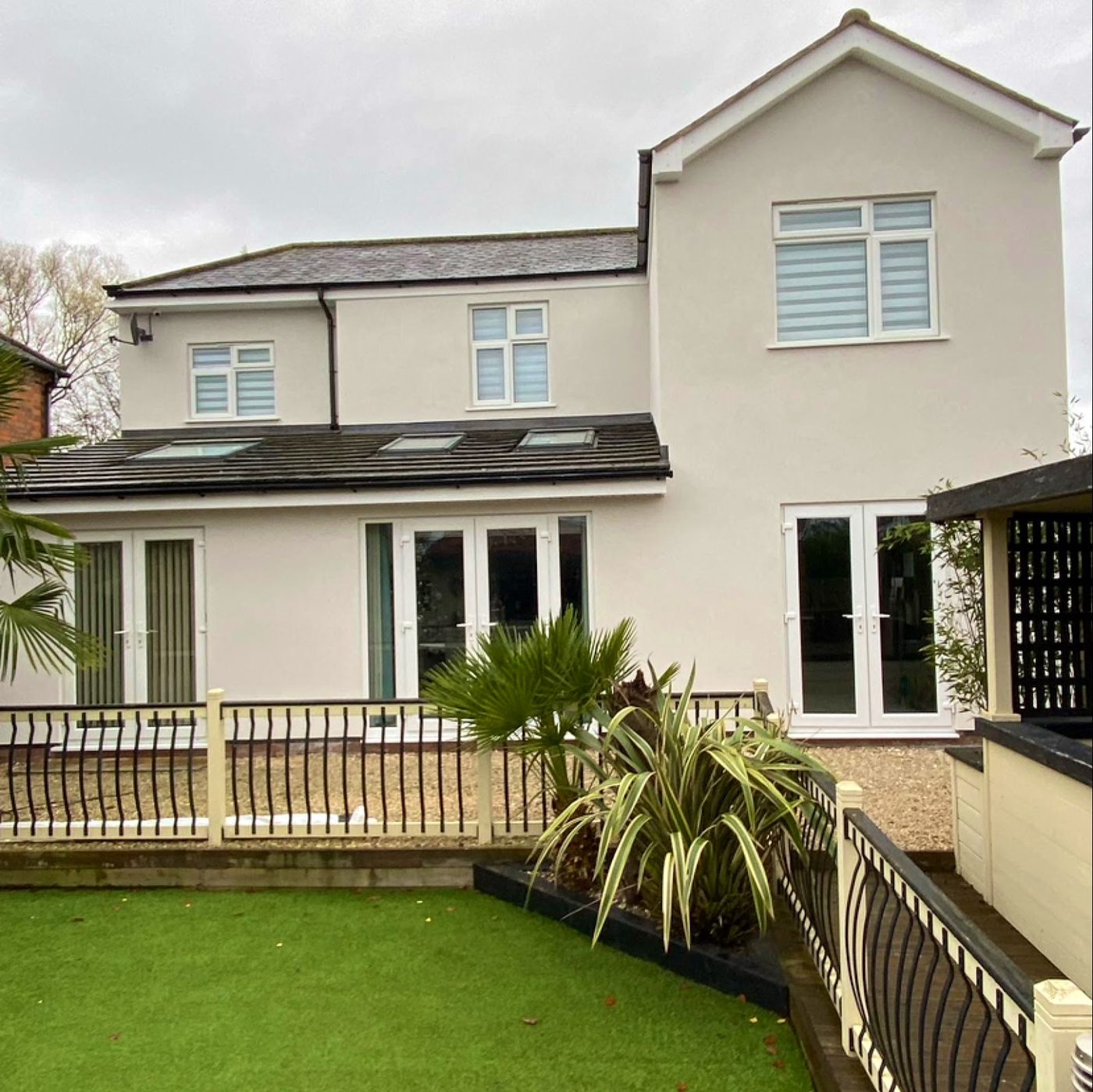 Cream rendered rear with balustrade and lawn