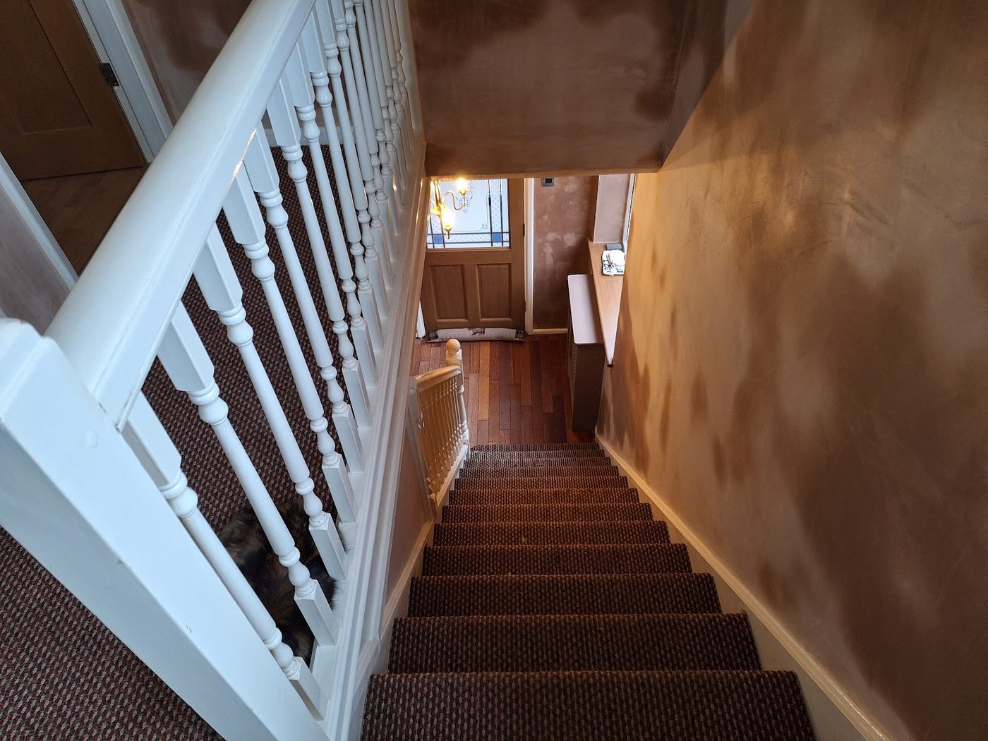 A hall and staircase part-way through a plaster skim
