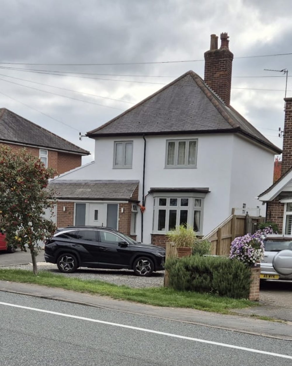 White rendered detached house from the road